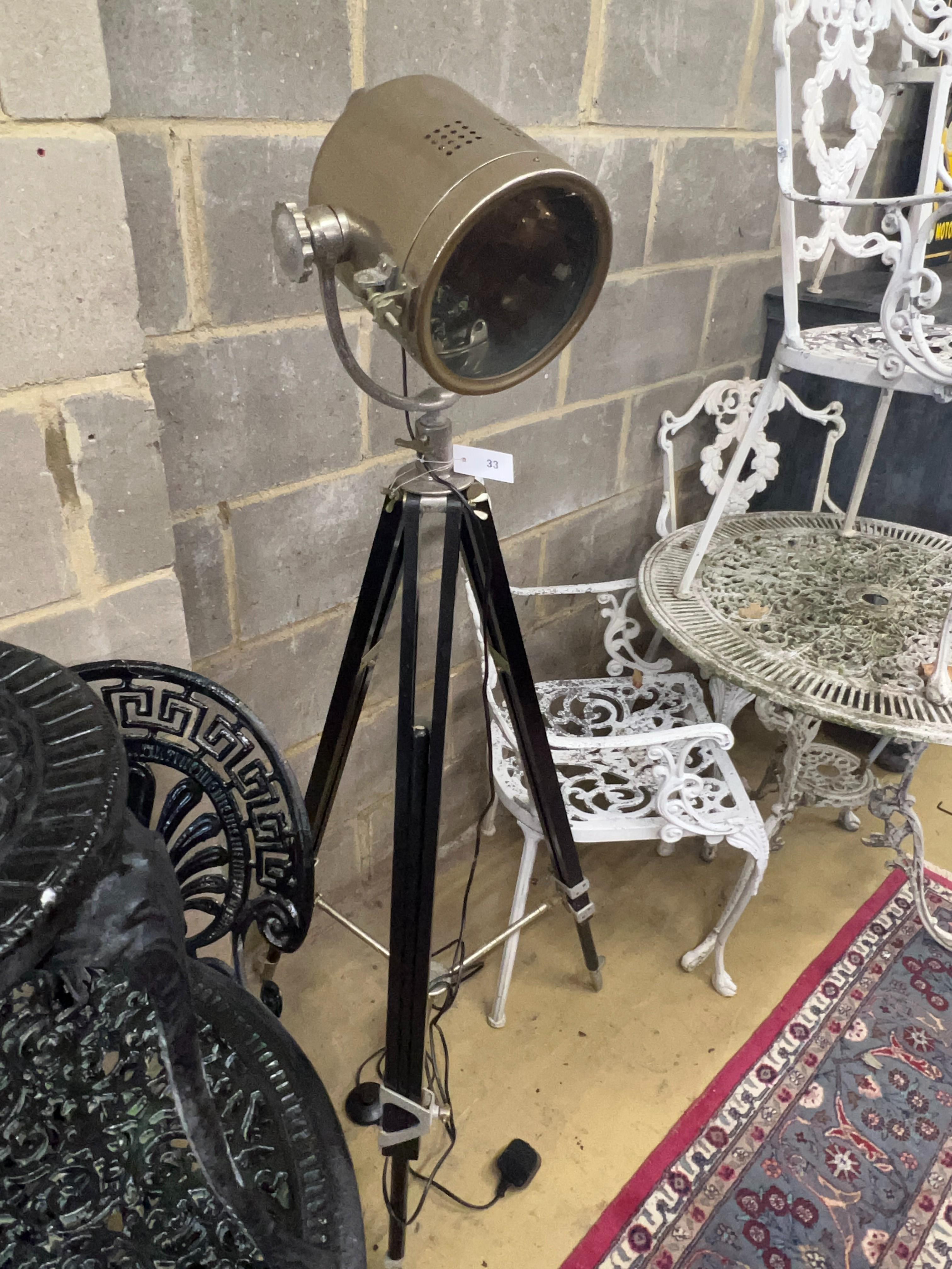 A modern ‘’searchlight‘’ style floor lamp, on a folding tripod base, height 144cm